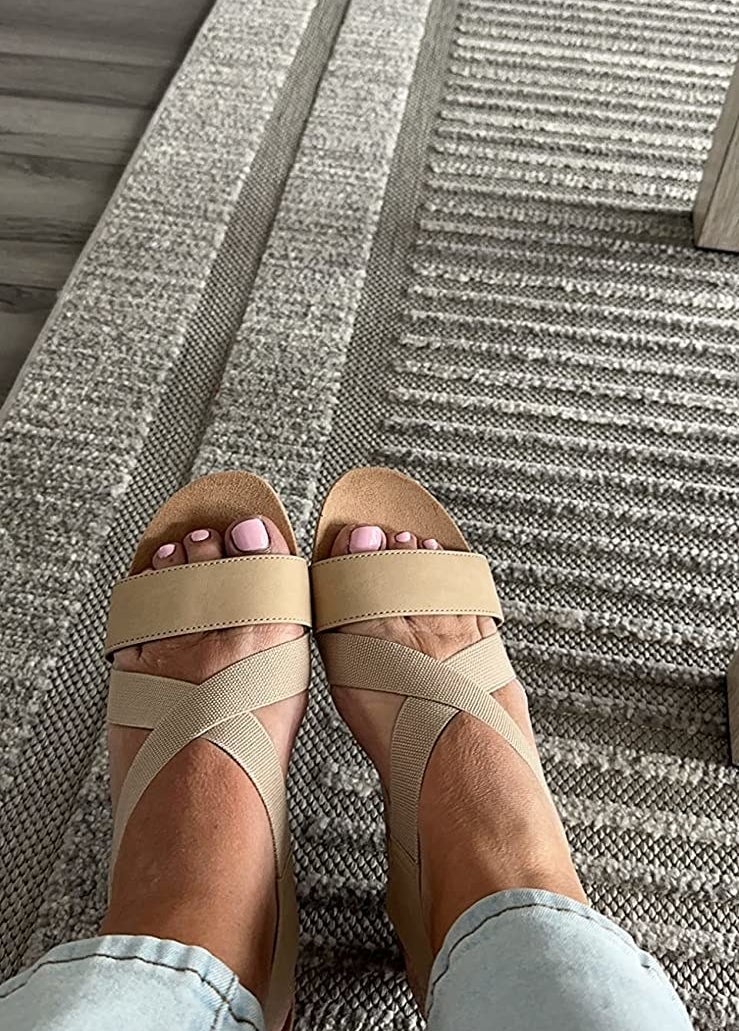 A reviewer wearing tan sandals