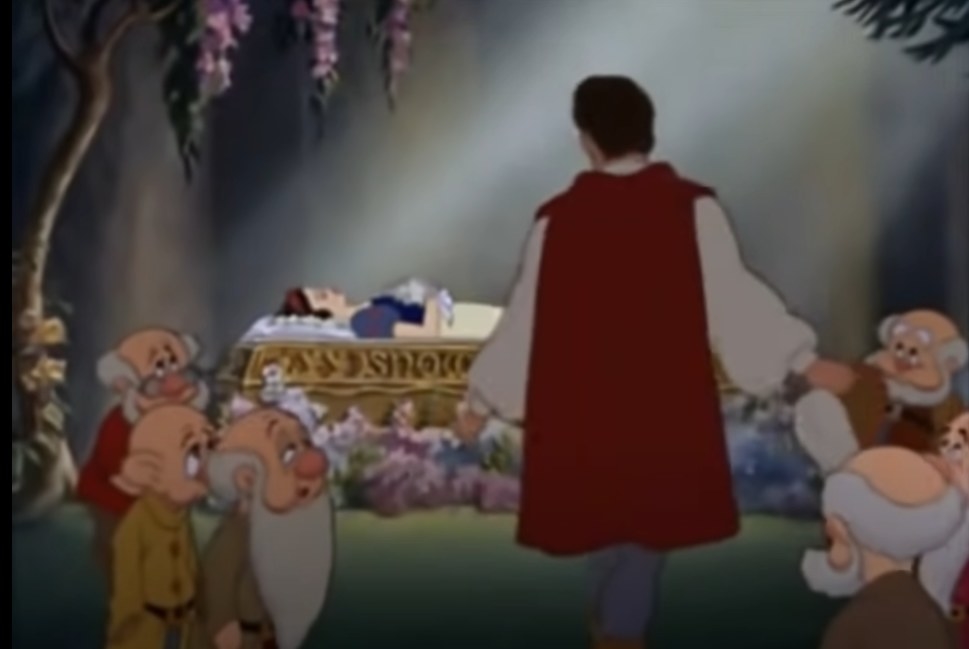 The prince and the seven dwarves standing around Snow White&#x27;s coffin