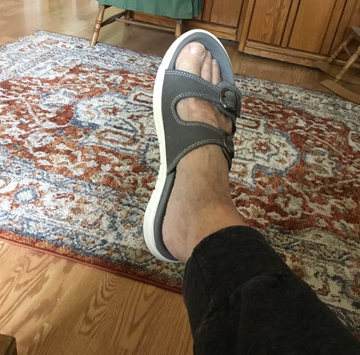 A reviewer wearing grey sandals