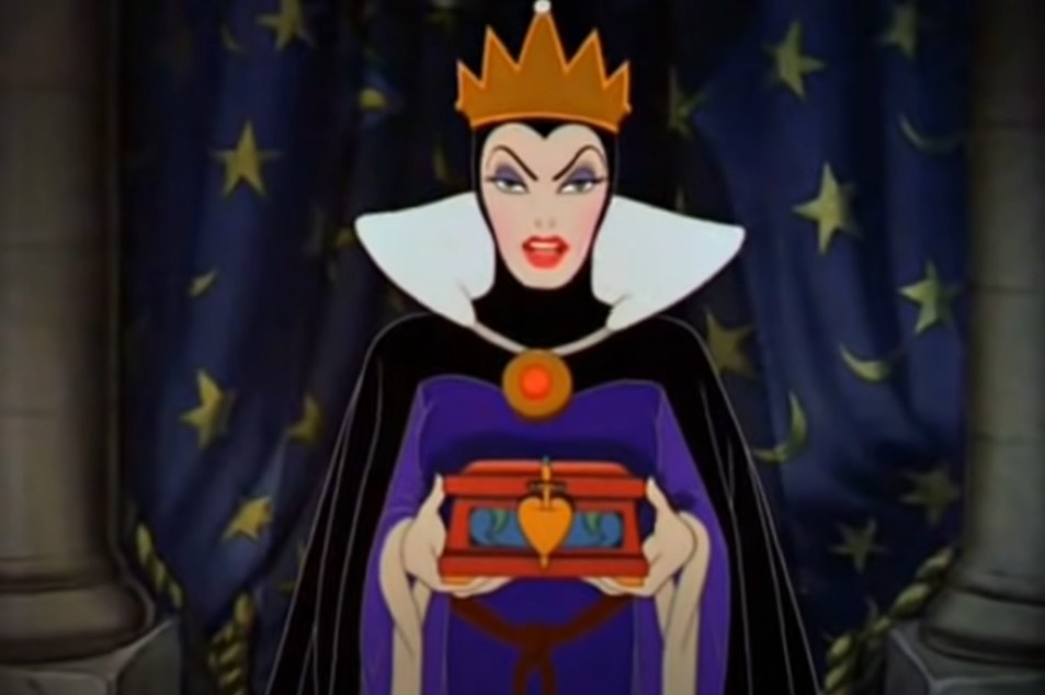 The evil queen in Disney&#x27;s Snow White looking evil and clutching a box with a speared heart icon on it
