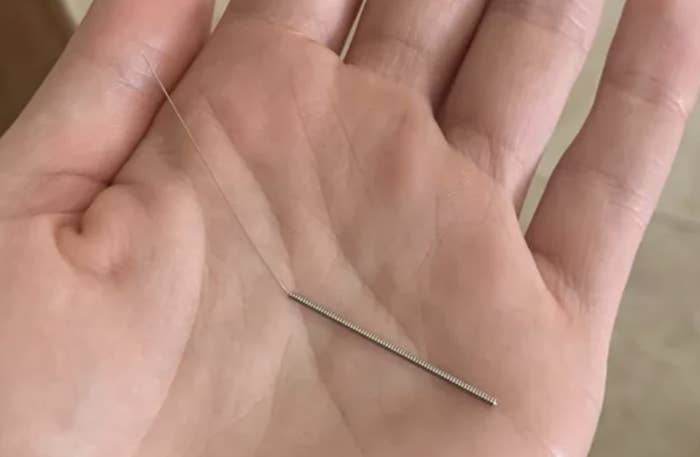 needle in the person&#x27;s palm