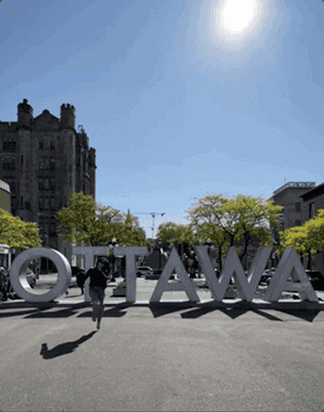 GIF of the writer skipping in front of the Ottawa sign