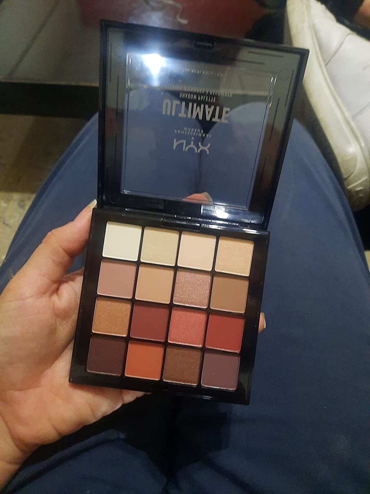 Reviewer holding the eyeshadow palette