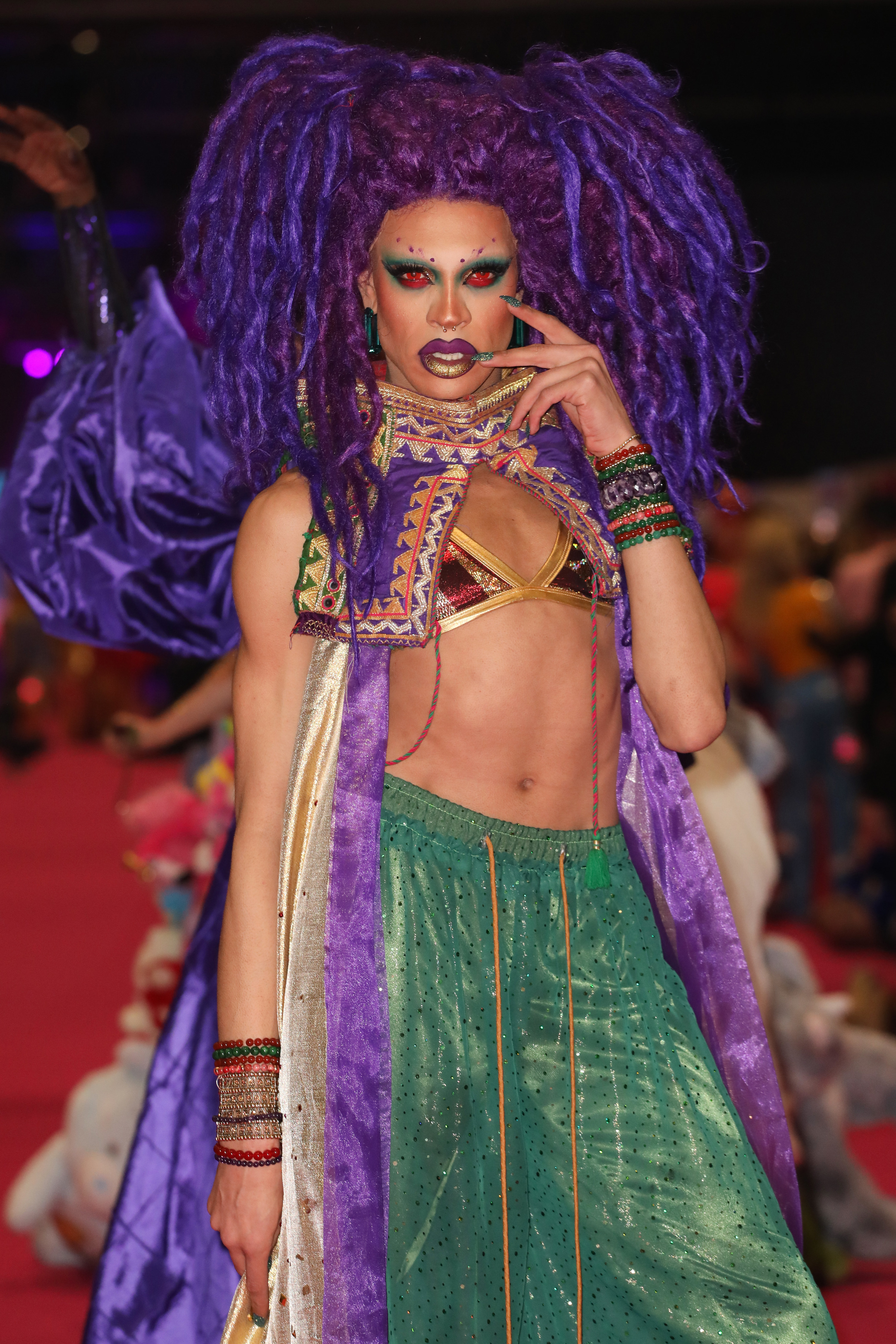 yvie oddly poses for a photo in a bikini top and pants