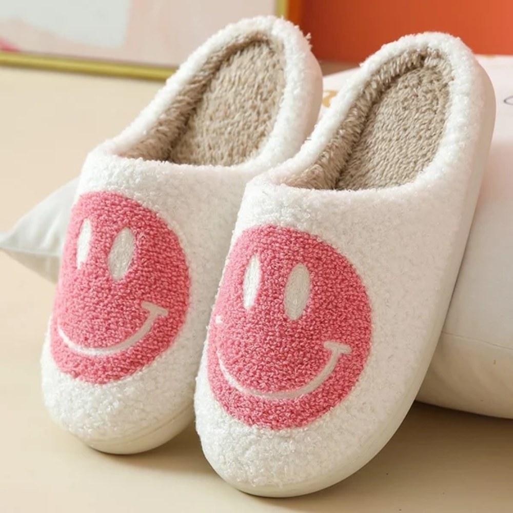 Pair of white slippers with pink smiley faces