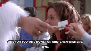 teen dressed as santa passing gifts in class saying, one for you and none for gretchen wieners bye