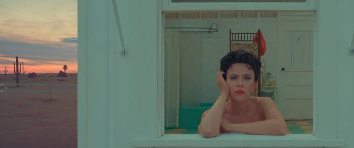 A closeup of Scarlett Johansson looking out of a bathroom window in a scene from Asteroid City
