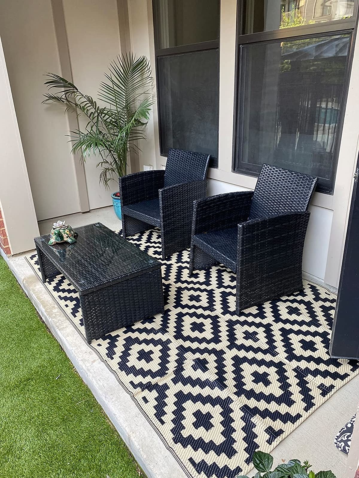 Reviewer photo of the rug outside with patio furniture on it