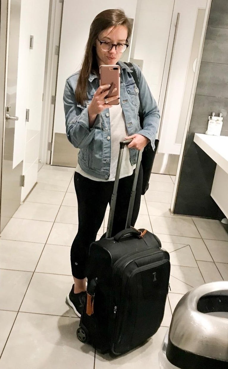 a reviewer wearing the jacket in an airport restroom