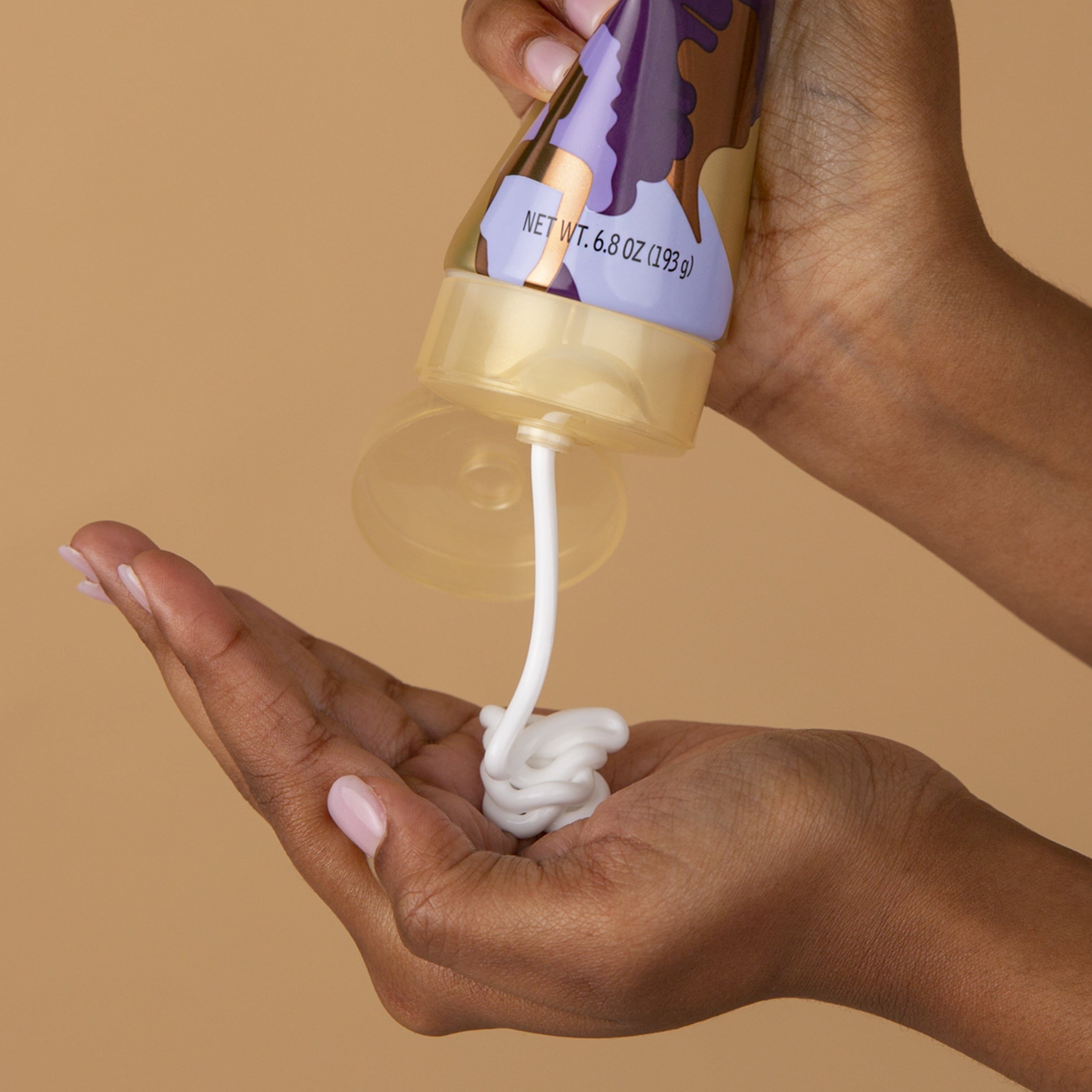 the hair cream squirted into the model&#x27;s hand