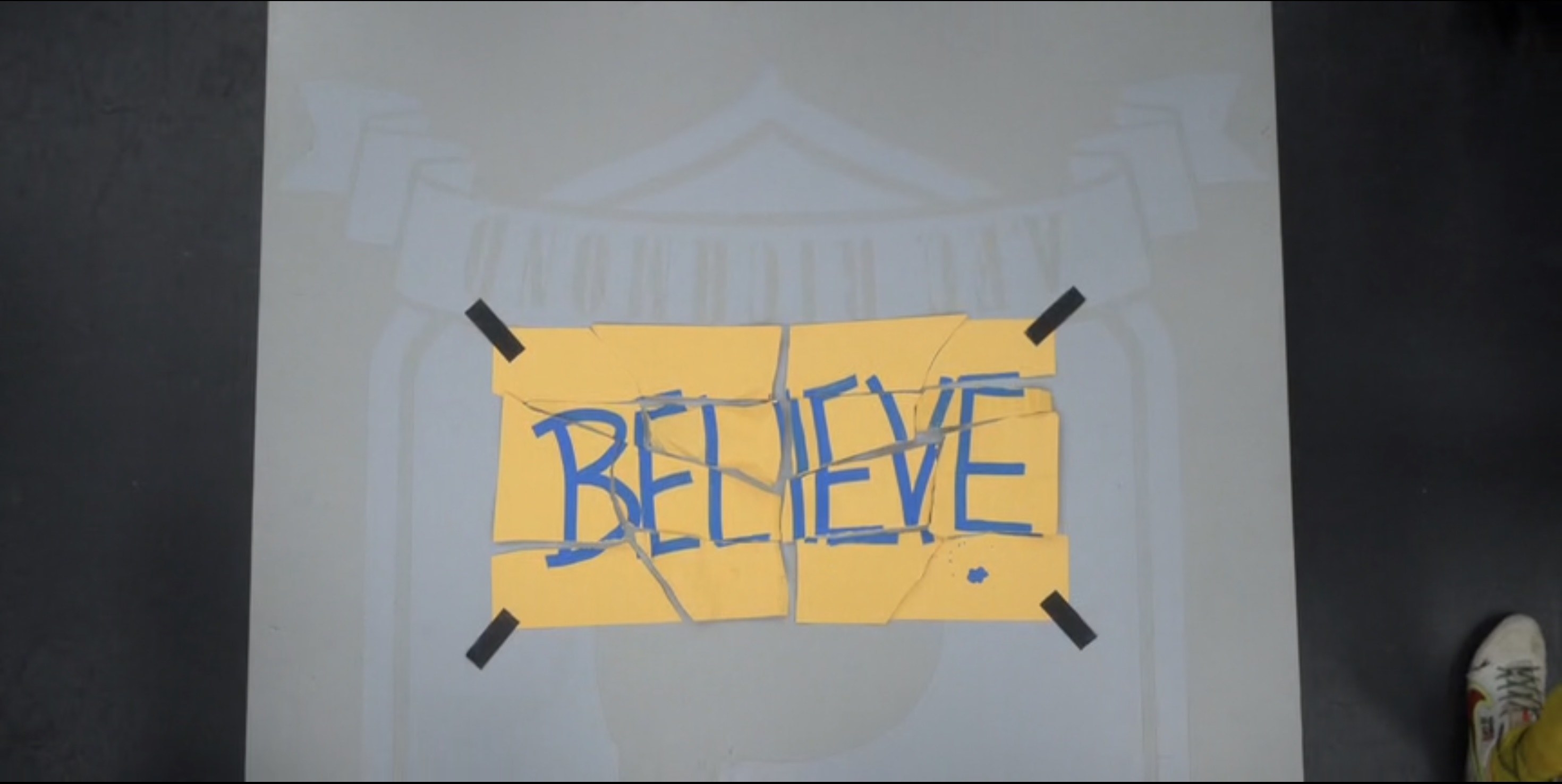 A tattered sign that says &quot;Believe&quot;
