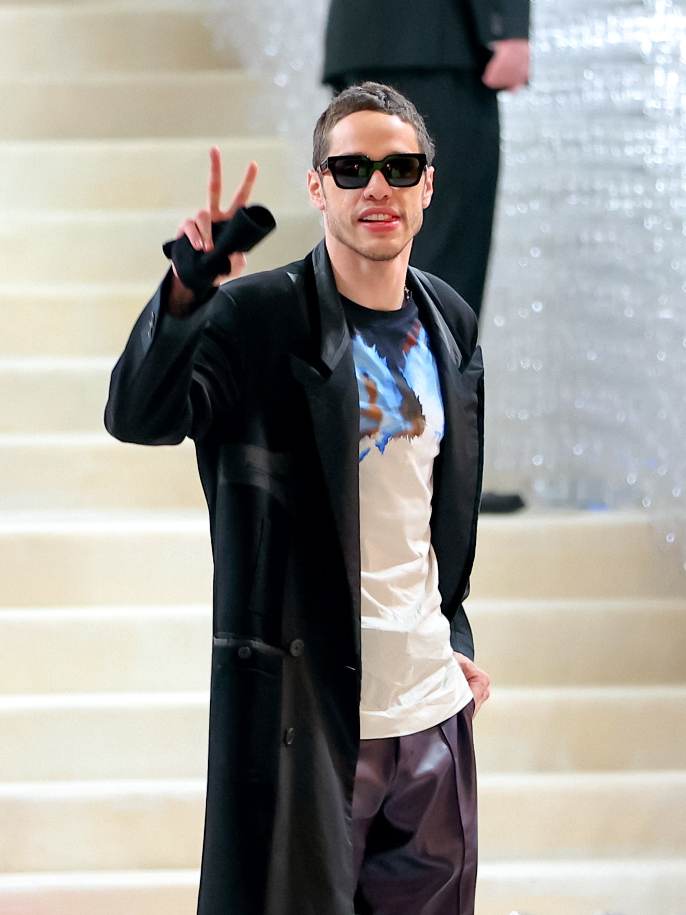 Pete giving a peace sign on stairs