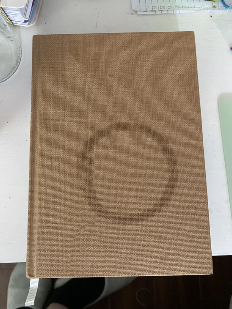 A drink ring on a notebook cover