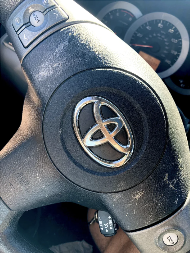Close-up of a steering wheel with stains on it