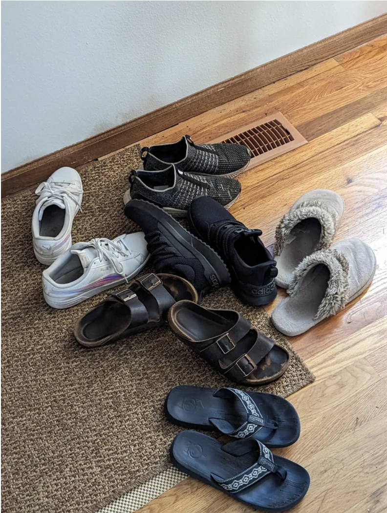 A pile of shoes on a mat