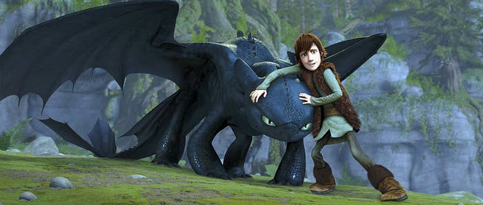 A smallish Viking holding onto a dragon