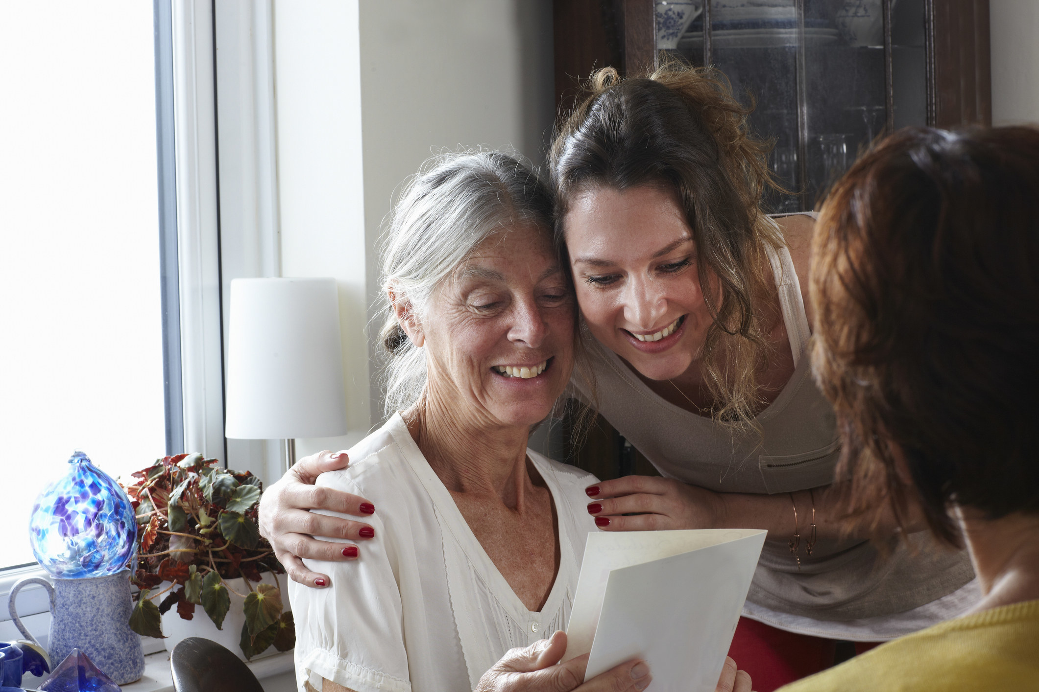 A mother and daughter reading a card together
