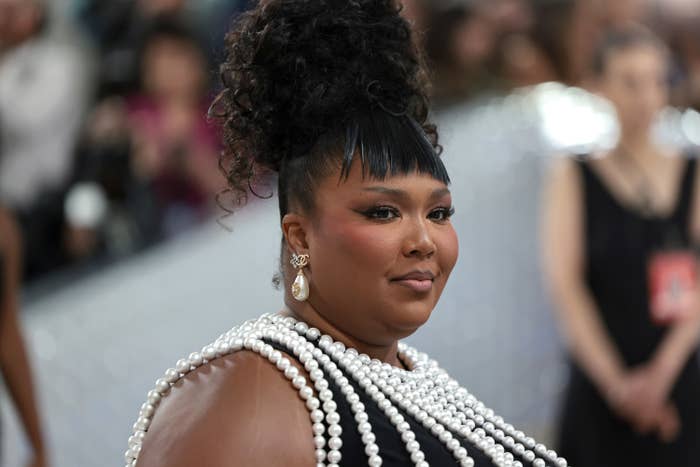 A closeup of Lizzo in a pearl beaded outfit