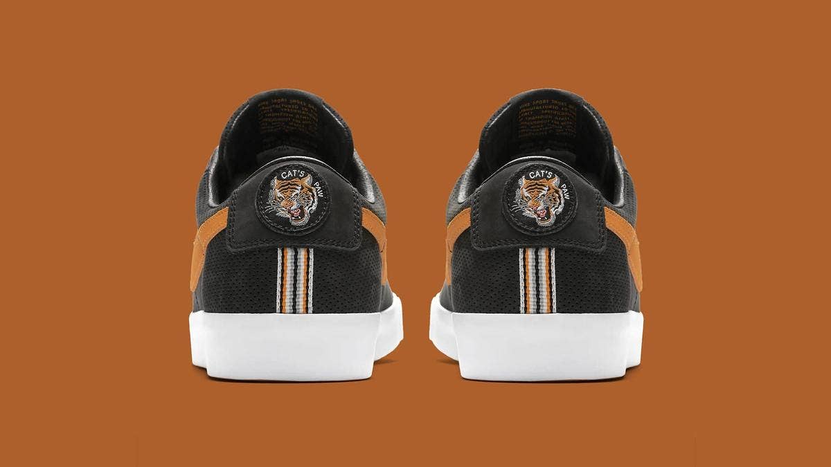 The legendary Cat's Paw Saloon in Portland, Oregon has designed its own Nike SB Blazer Low GT collaboration. The black and orange colorway is highlights by a tiger head embroidered on the heel. 