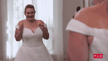 A woman excited about her wedding dress and high-fiving