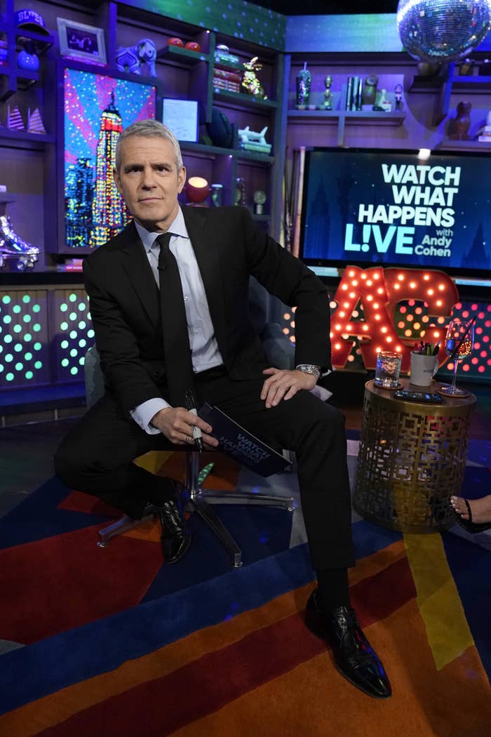 andy cohen poses for a photo on the set of his talk show