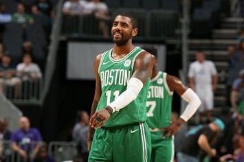 Kyrie Irving smiles on the court for the Celtics.