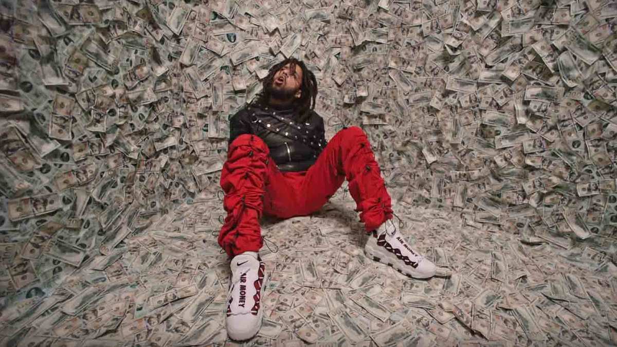 J. Cole wears the Nike Air More Money sneakers in his new 'ATM' music video from the 'KOD' album.