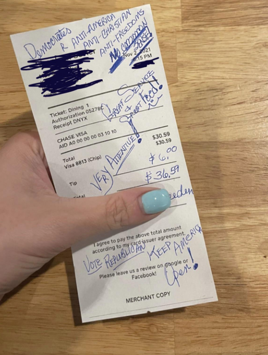 A receipt with a tip, but a political note written in blue ink
