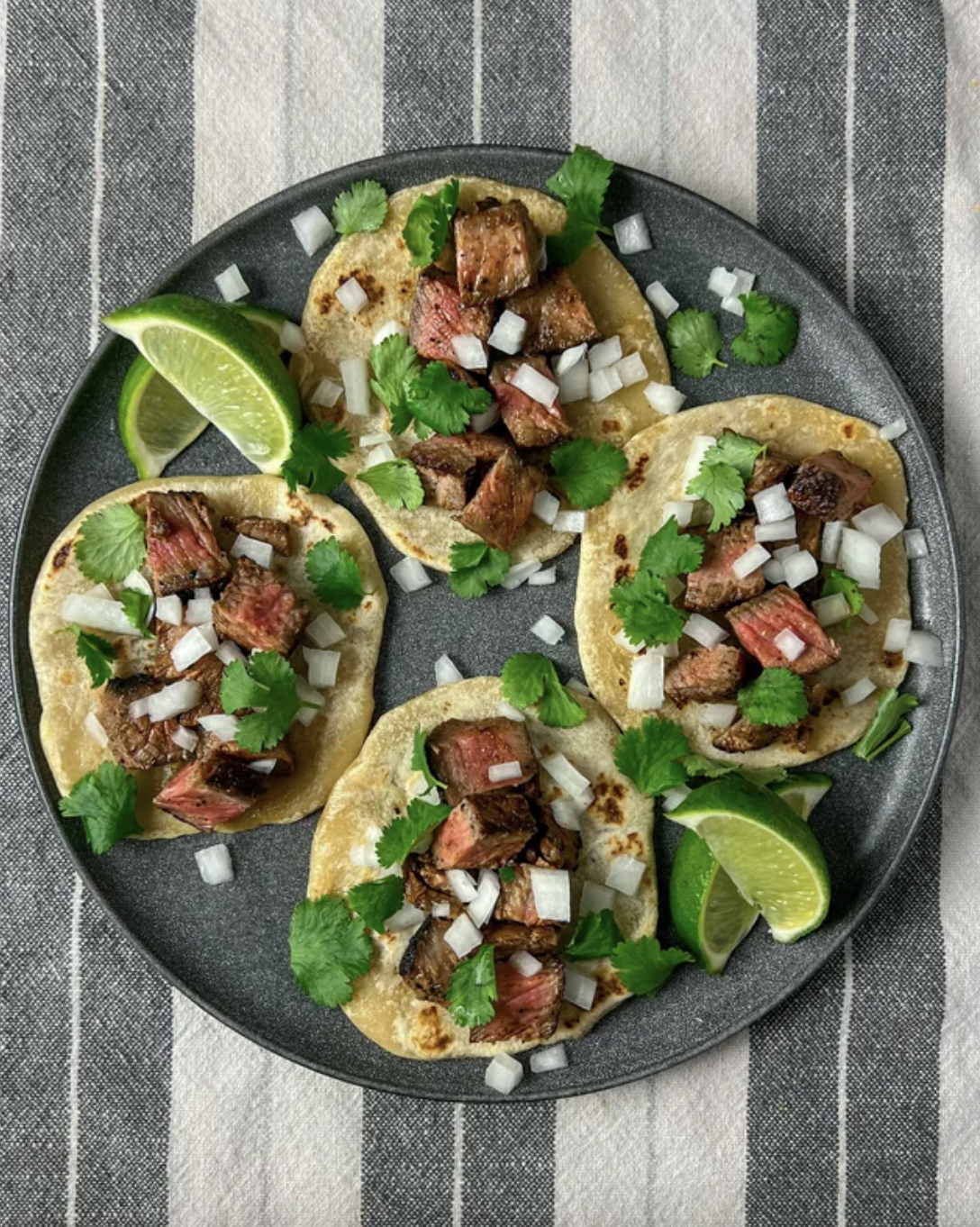 plate of tacos with lime wedges