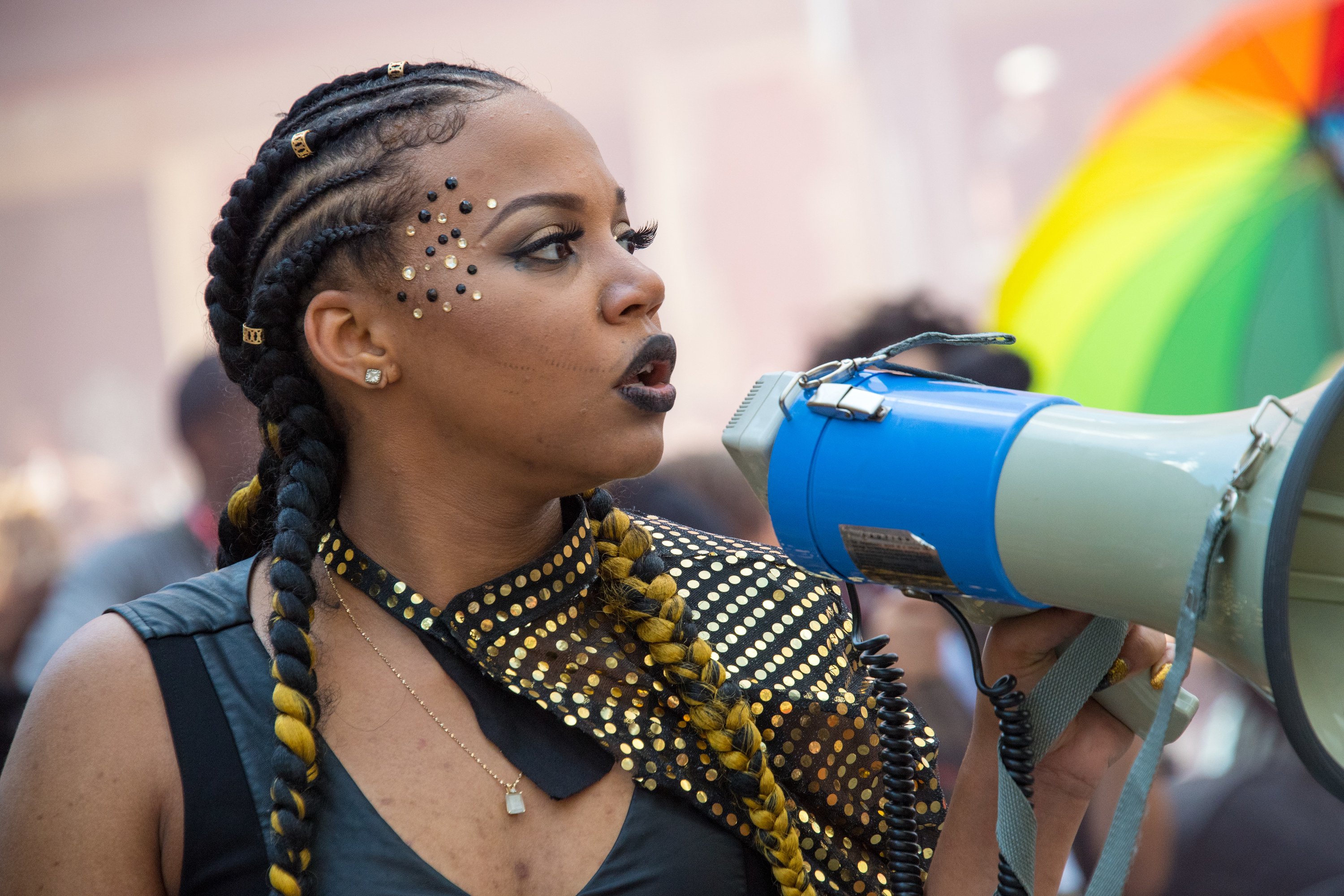 A member of Black Lives Matter holding a megaphone at the Pride Parade