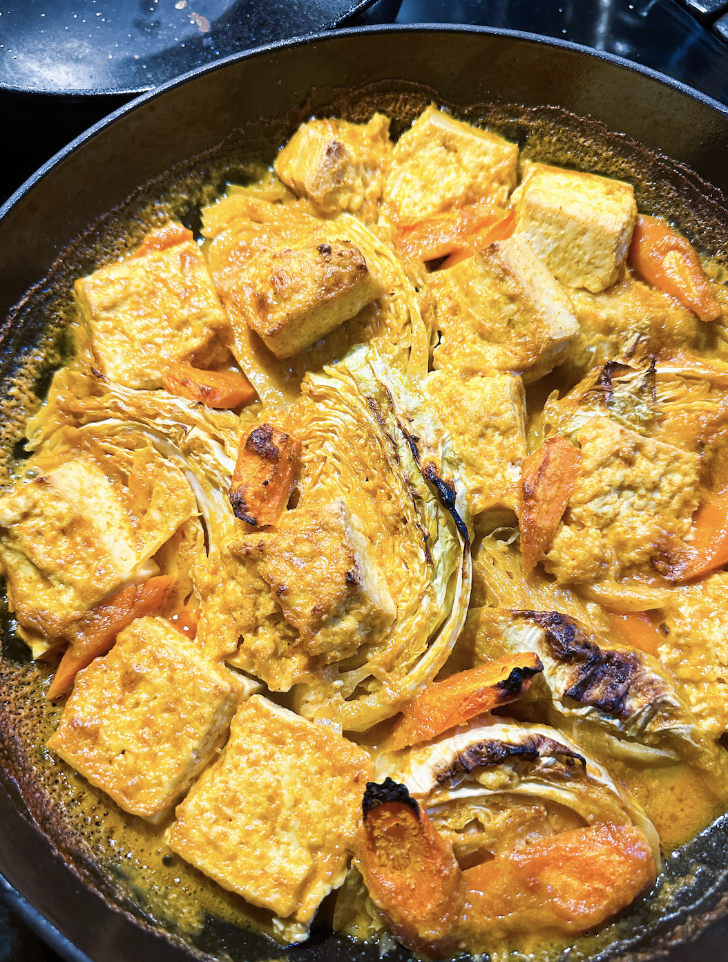 dish of caramelized tofu, cabbage, and carrots in a curry sauce