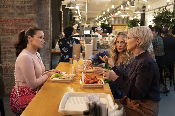 Carrie, Miranda, and Charlotte eating at a restaurant