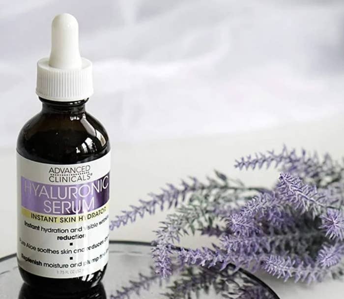 A bottle of face serum with lavender