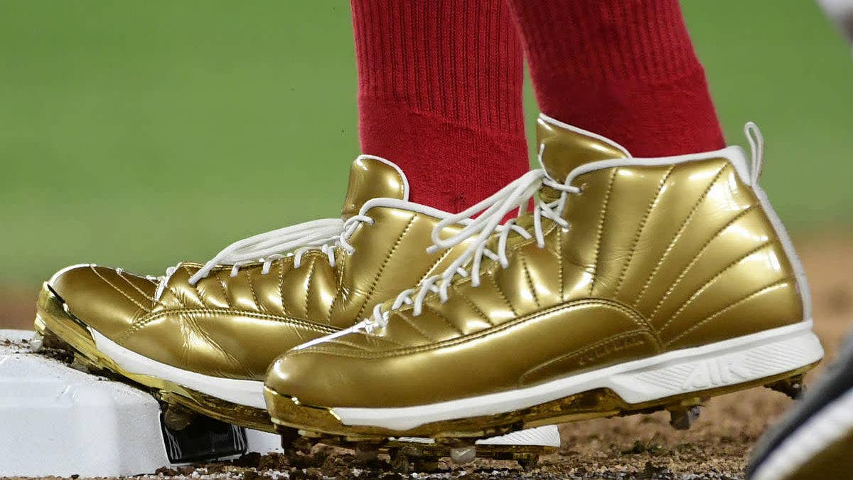 Jordan athletes like Mookie Betts, Dexter Fowler and Manny Machado wear gold Air Jordan 12 cleats in support of Childhood Cancer Awareness.