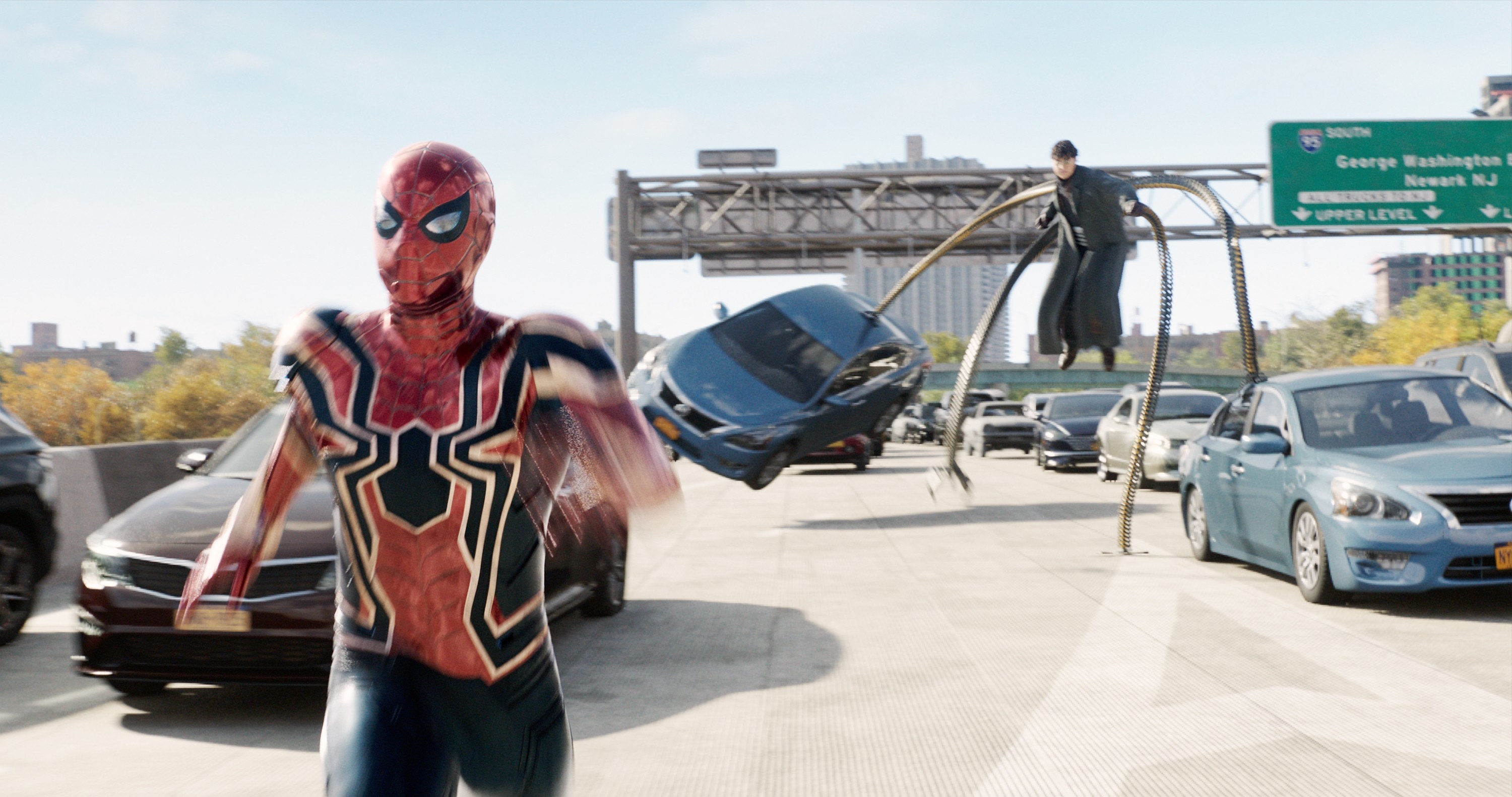 Spider-Man running through traffic with Doc Ock behind him