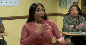 Megan Thee Stallion gasping and clutching her chest
