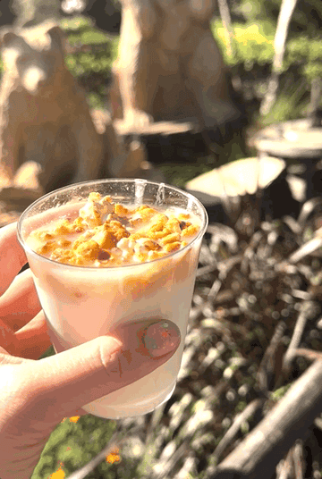 A slushie drink topped with popcorn