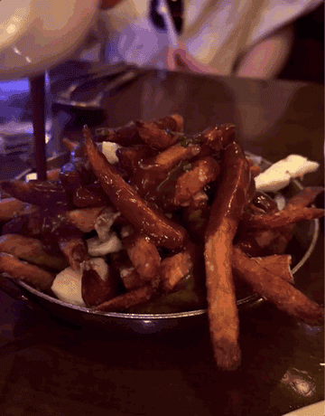 Gif of gravy getting poured on poutine