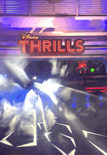A gif of strobing lights with a neon &quot;Disney Thrills&quot; sign