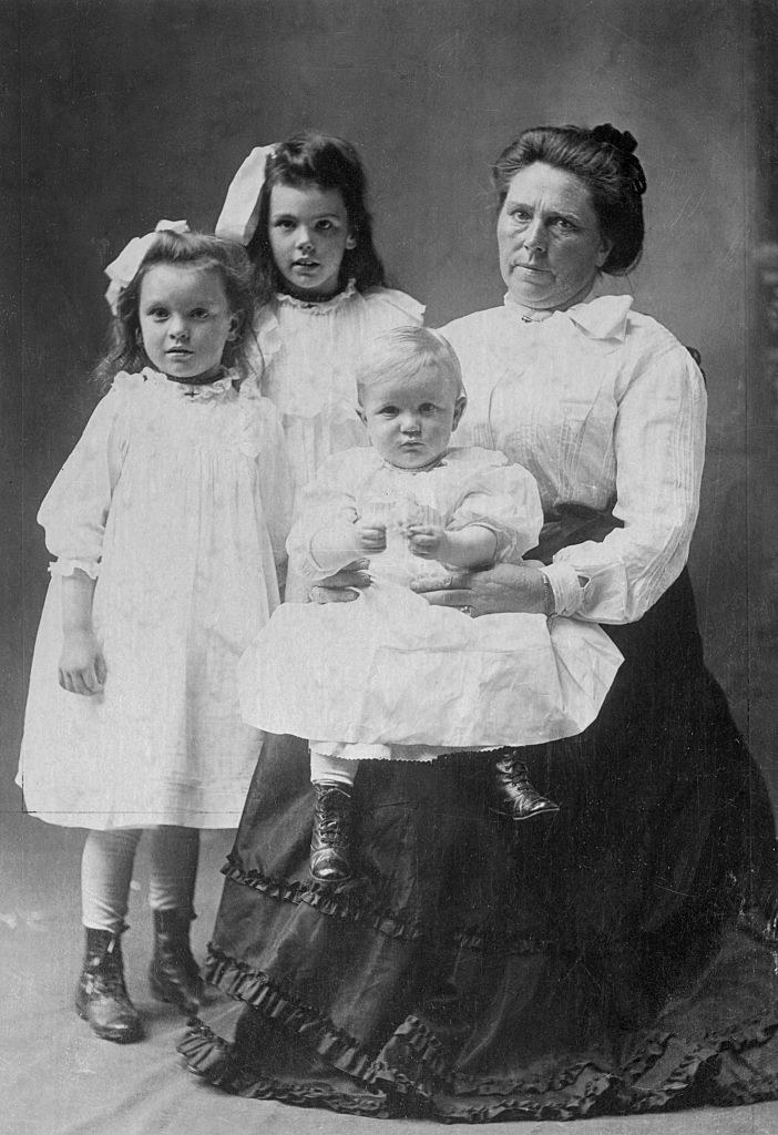Belle with her children siting for a portrait
