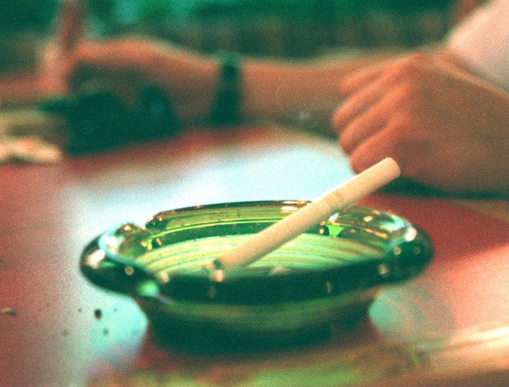 A lit cigarette in an ashtray