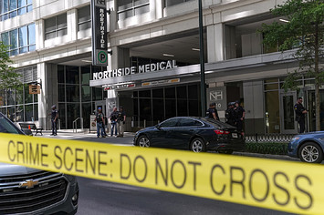 Police tape blocks access to Northside Hospital medical facility after shooting.
