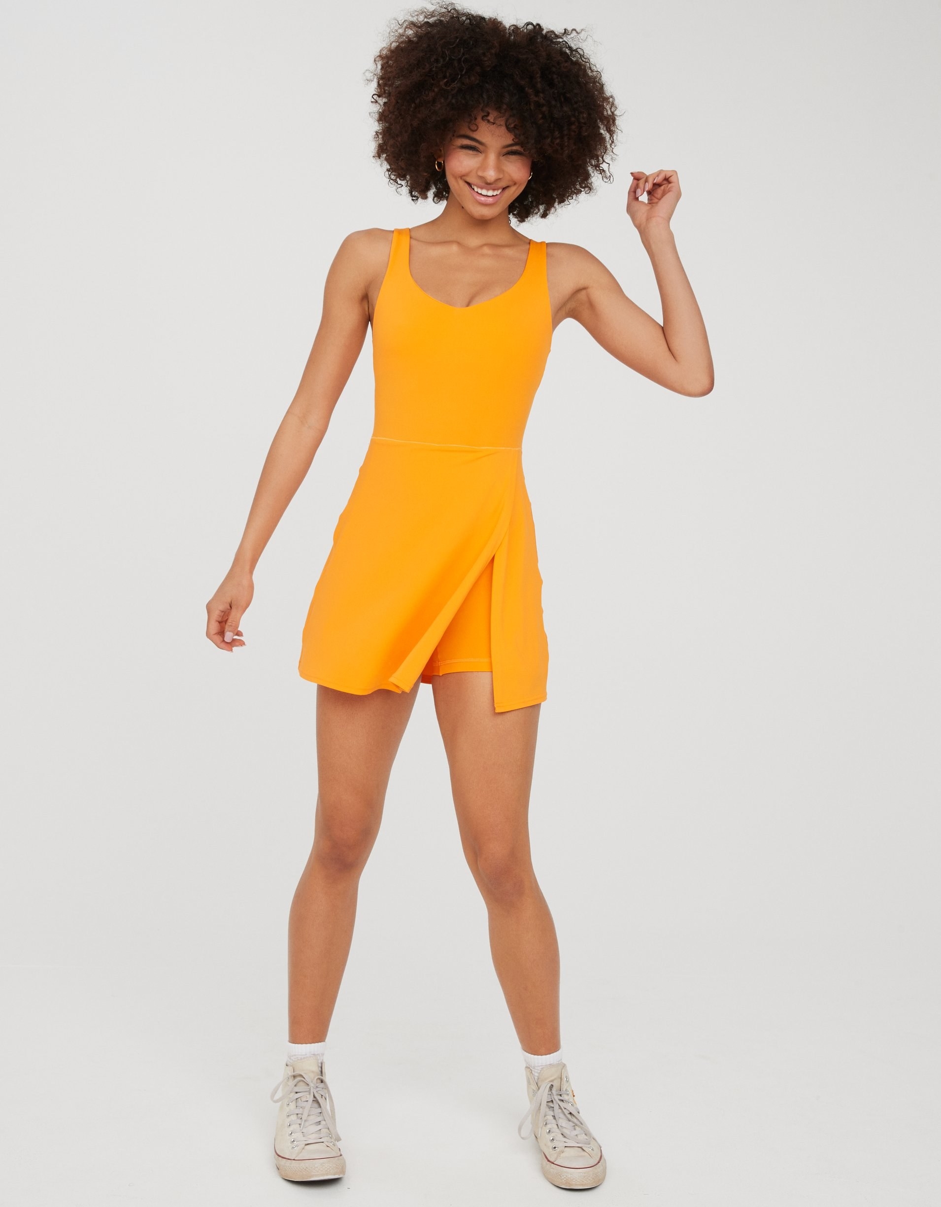 model in bright yellow scoop-neck tank dress with built-in shorts and a slit up its skirt