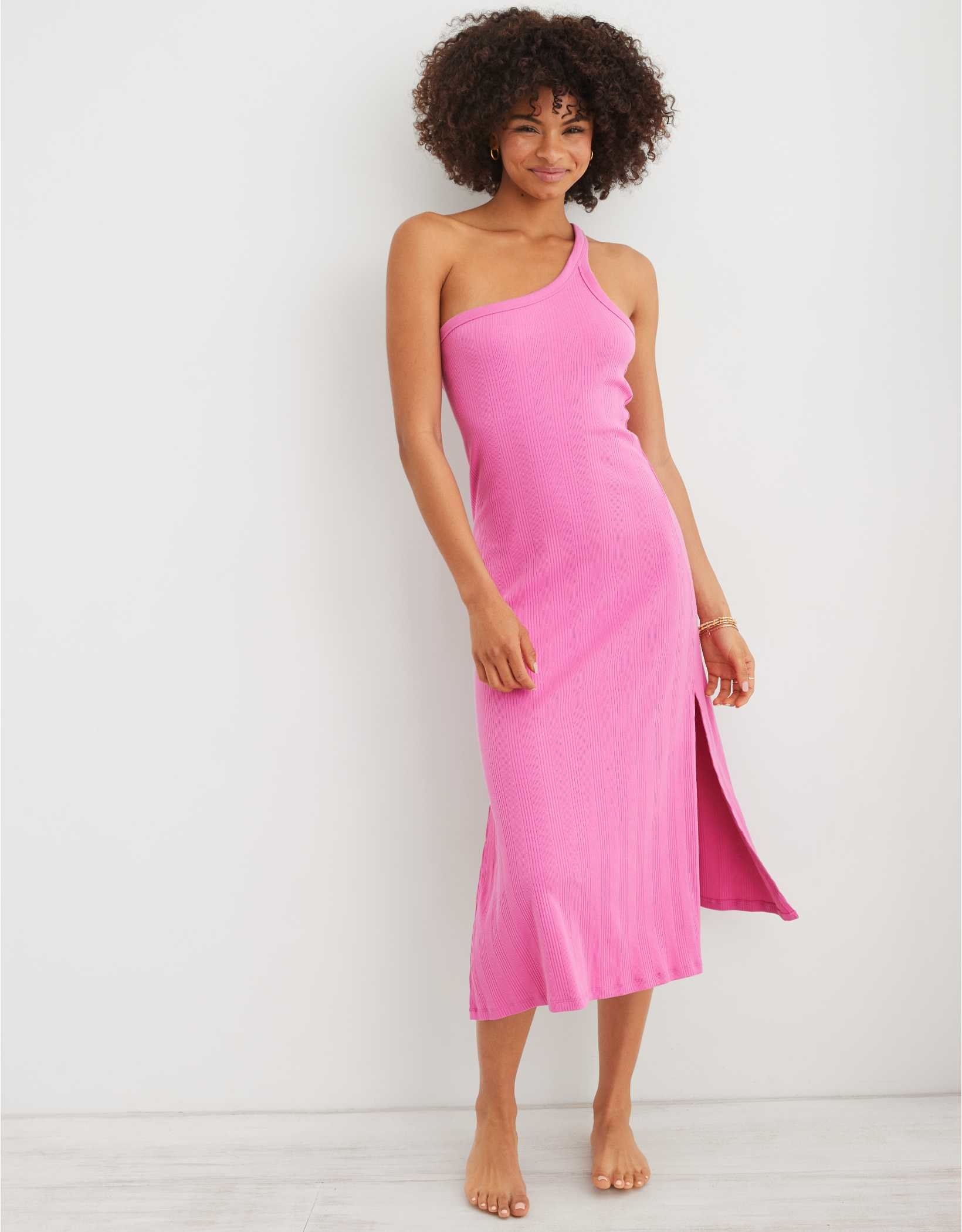 model in bright pink midi ribbed dress with a slit one one tank sleeve