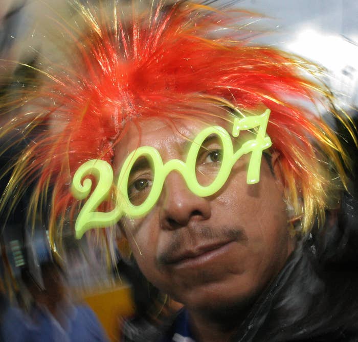 A man wearing 2007 glasses and an orange wig