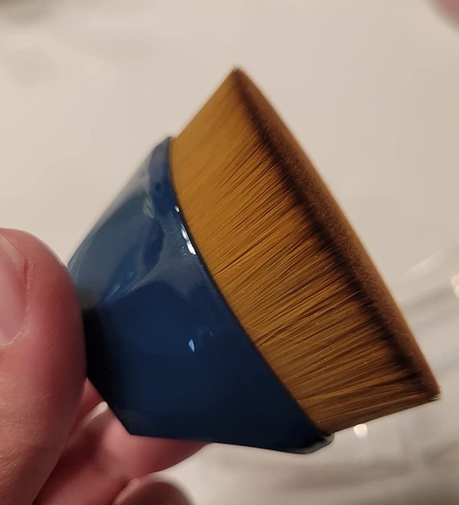 A small round fine bristled makeup brush