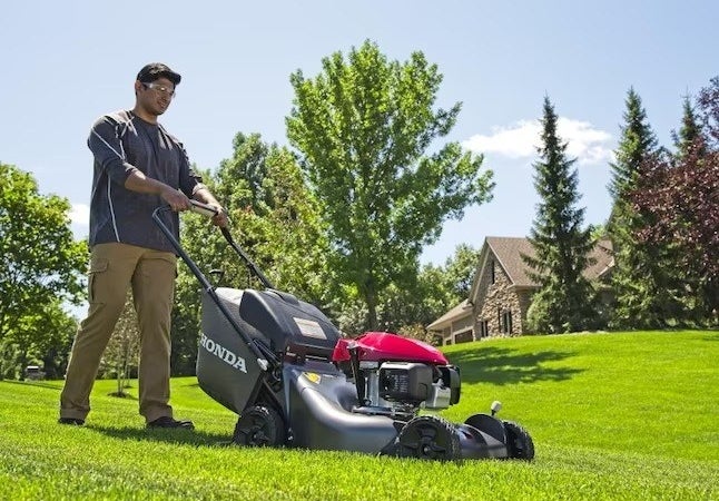 model mowing lawn with black Honda self-propelled gas lawn mower