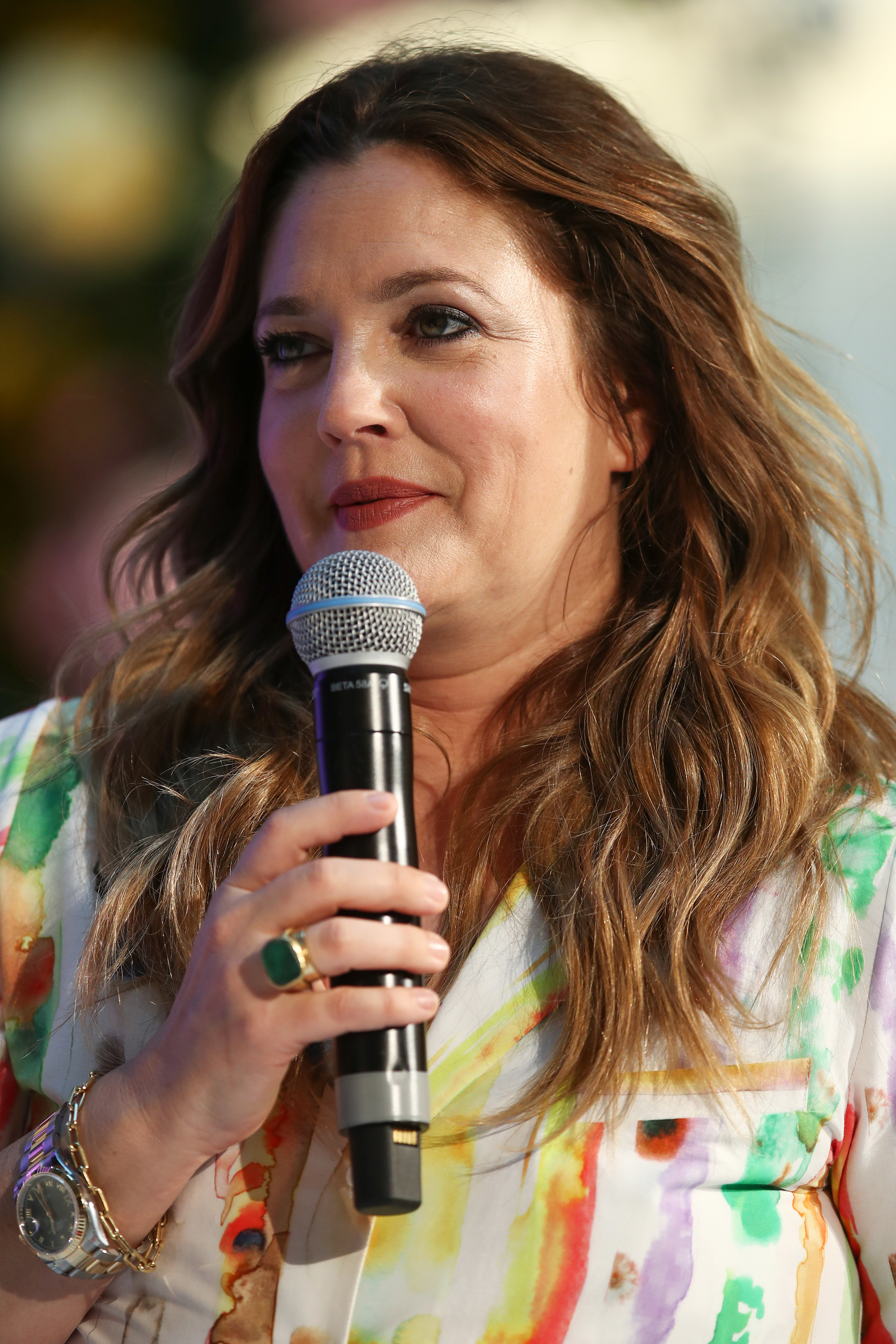 Closeup of Drew Barrymore holding up a microphone