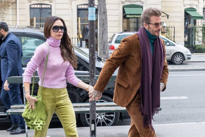 Closeup of Victoria and David Beckham walking while holding hands
