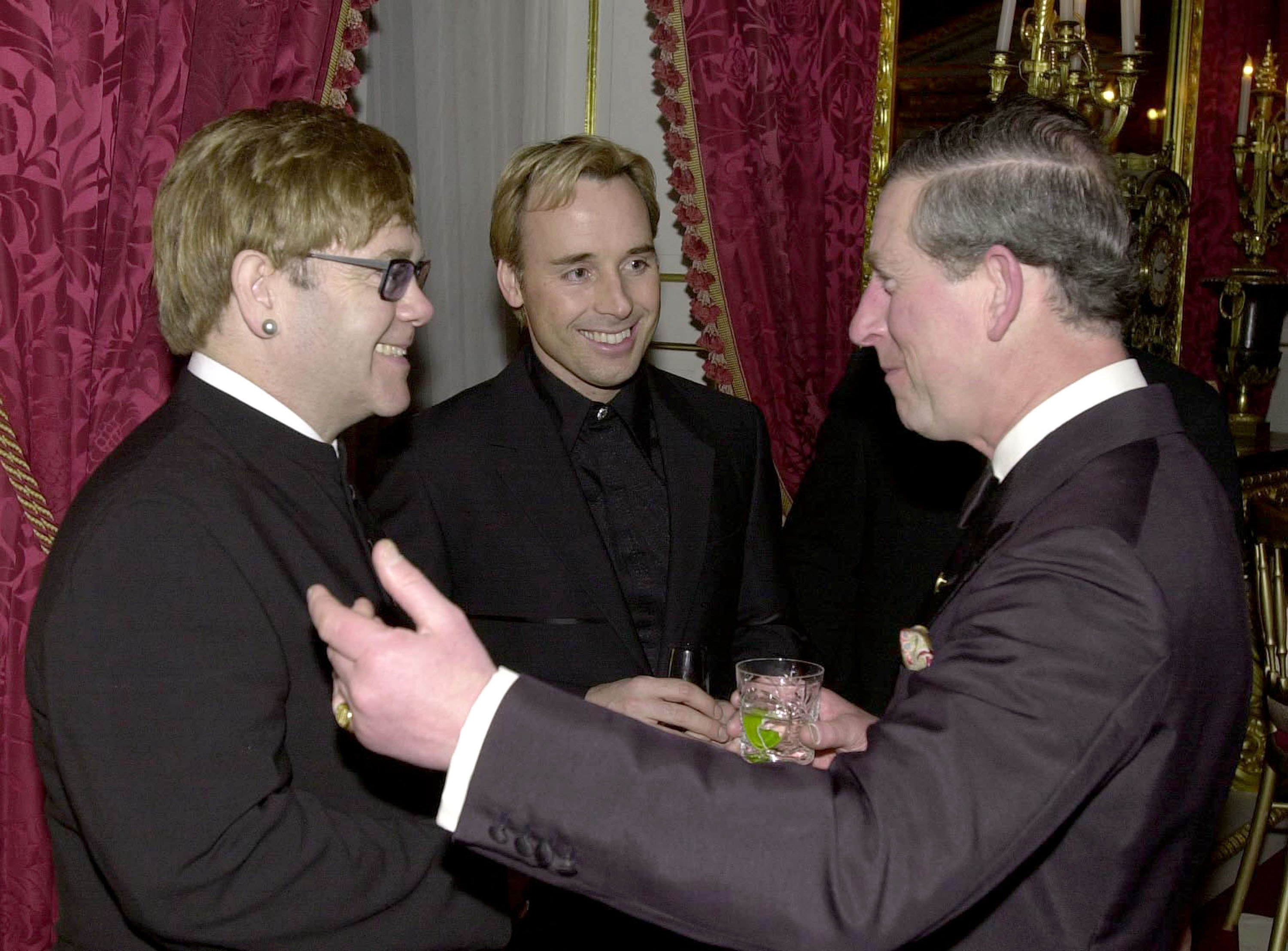 Elton and Charles smiling at each other